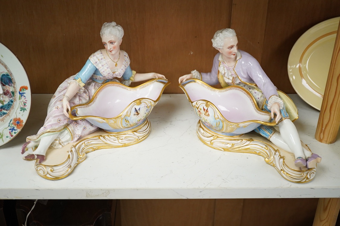 A pair of French porcelain figural sweet meat dishes, late 19th century, 34.5cm